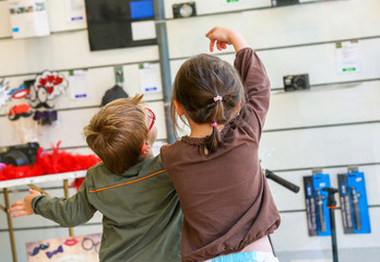 Two kids looking at the products in a store