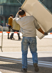 A man carrying a big board with foil framing