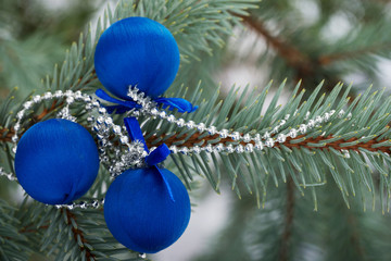 Three christmas balls on a tree.