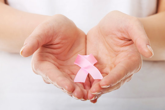 Hands holding pink breast cancer awareness ribbon