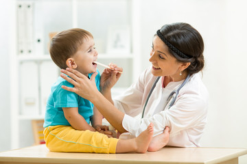 doctor examining little boy isolated on white background