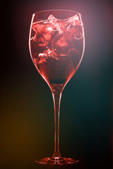 Cocktail with ice cubes on dark background