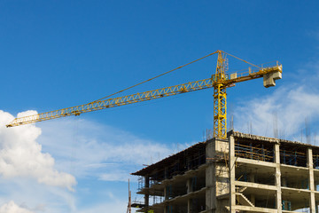 Tower Crane Wide Screen and Skyscraper on Blue Sky Background