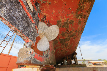 Ship waiting for repairs on a dry dock ,Two-blade propeller, mad