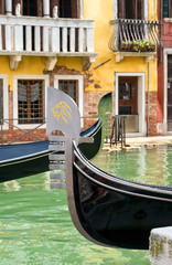 Fototapeta na wymiar Gondola moored on a venetian canal - Venice, Italy
