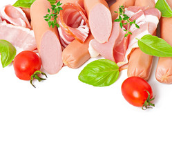 Delicate meats (sausage and ham) decorated with basil and tomato