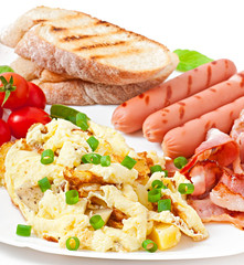 English breakfast - scrambled eggs, bacon, sausage and toast