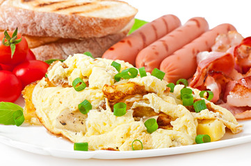 English breakfast - scrambled eggs, bacon, sausage and toast