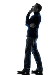 Naklejka premium man looking up pensive silhouette full length
