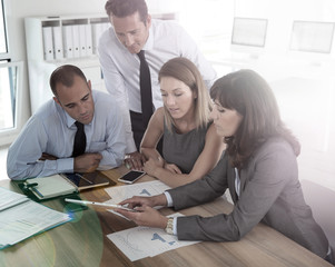 Fototapeta premium Group of business people meeting around table wih tablet