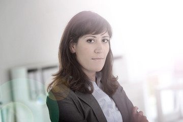 Smiling young businesswoman looking at camera