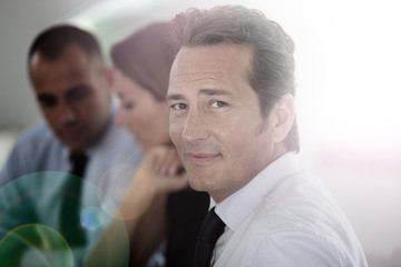 Portrait of confident businessman attending meeting