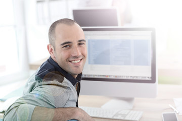 Portrait of student in front of desktop computer