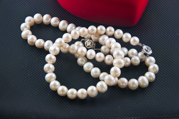 Pearl necklace against a black background