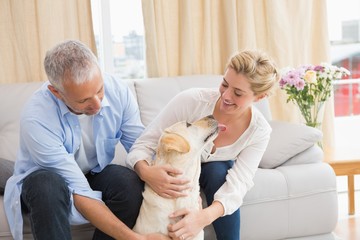 Obraz na płótnie Canvas Happy couple with their pet dog