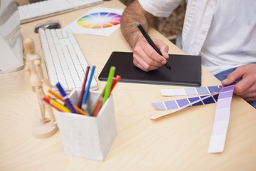 Artist drawing something on graphic tablet