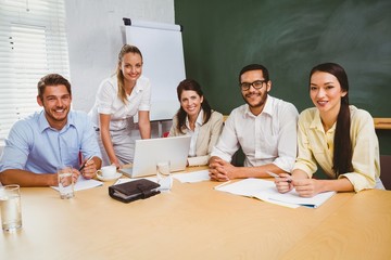 Casual business team having a meeting using laptop