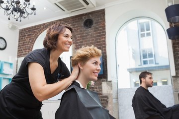 Smiling hairdresser chatting with customer © WavebreakMediaMicro