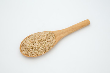 Brown rice in a wooden spoon