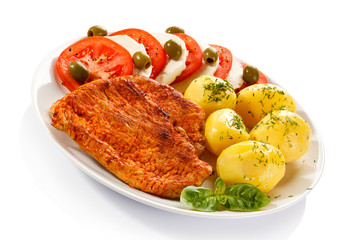 Fried pork chops, boiled potatoes and caprese salad