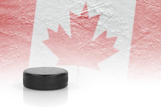 Hockey puck and a Canadian flag