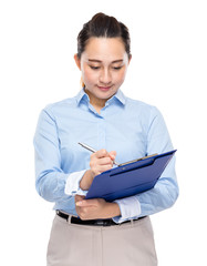 Businesswoman write on clipboard