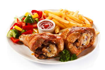 Grilled turkey legs with French fries and vegetables