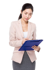 Asian businesswoman write on clipboard