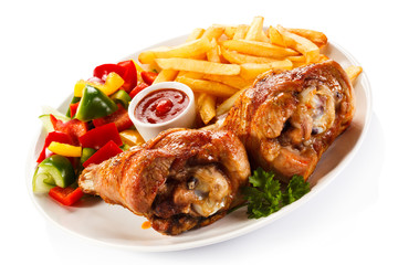 Grilled turkey legs with French fries and vegetables