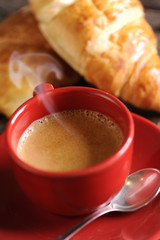 Croissants and coffee on wooden table