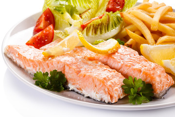 Grilled salmon and vegetables on white background