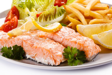 Grilled salmon and vegetables on white background