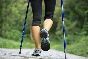 Fototapeta na wymiar young fitness woman legs walking on forest trail 