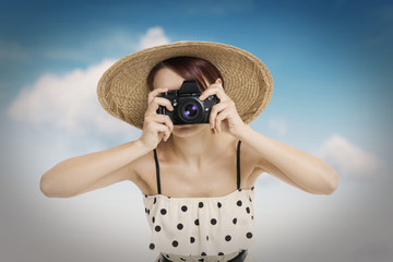 Beautiful woman photographer holding photo camera