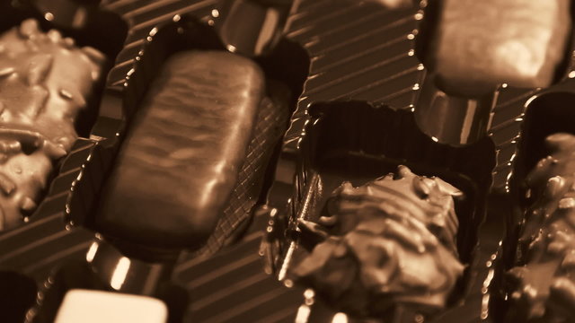 close up panning across box of chocolates (dolly shot)