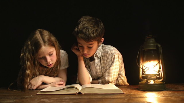 Siblings Reading a Book