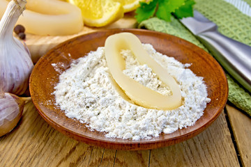 Calamari ring in flour on board
