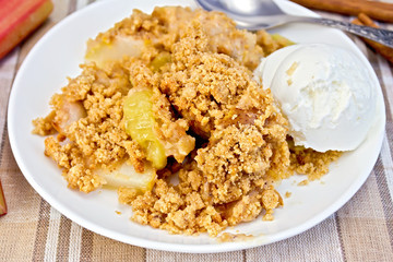 Crumble with rhubarb in dish on linen tablecloth