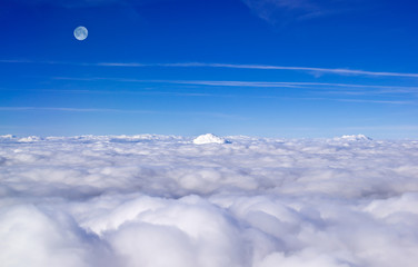 Panorama of clouds and moon from plane
