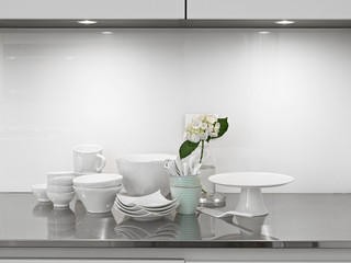 white ceramic dishes and vase of flower o in the modern kitchen
