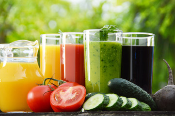 Glasses with fresh vegetable juices in the garden. Detox diet