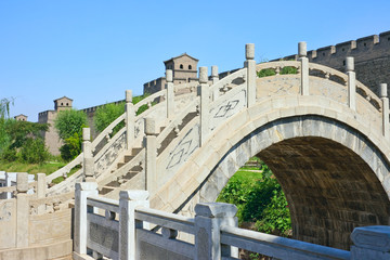 Arch bridge and the wall of an ancient fortress.