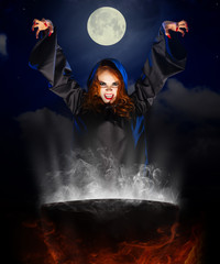 Witch with cauldron on night sky background