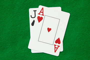 blackjack hand on green casino table