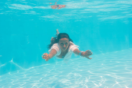 Young woman swimming undewater