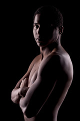 Naklejka premium dark-skinned young man with arms folded