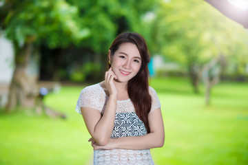 Fototapeta premium Portrait of young beautiful woman sitting on grass