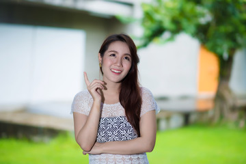 Portrait of young beautiful woman sitting on grass