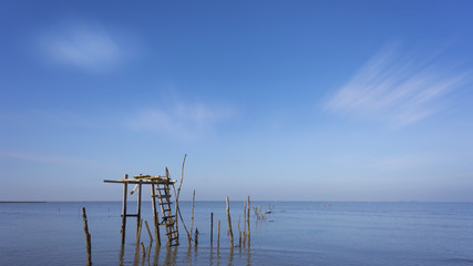 Fototapeta premium Old and abandon wooden platform at calm sea