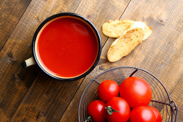 Homemade tomato juice in color mug, toasts and fresh tomatoes